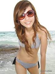 Sexy Oriental ex-girlfriend posing in a bikini outdoors