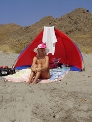 Blond hot milf enjoys naked sunbathing