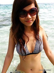 Sexy Oriental ex-girlfriend posing in a bikini outdoors